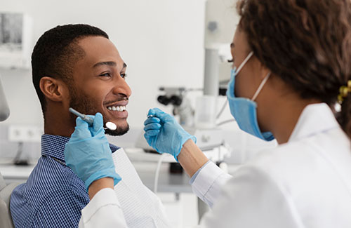 Smiling patient with a dental care provider.