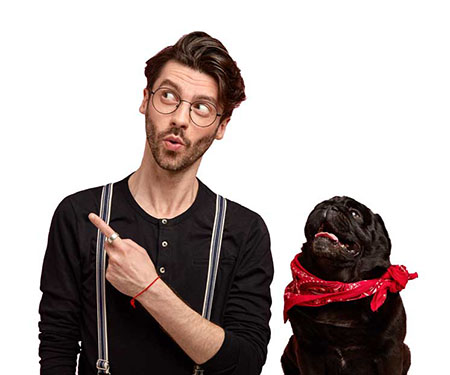 Man smiling with a dog pointing at our content.